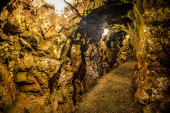 Tour underground mine tunnels by candlelight during 'A Golden Christmas.' Located in Midland, NC, Reed Gold Mine State Historic Site is the location of America's first gold discovery. - Photo credit: Visit Cabarrus