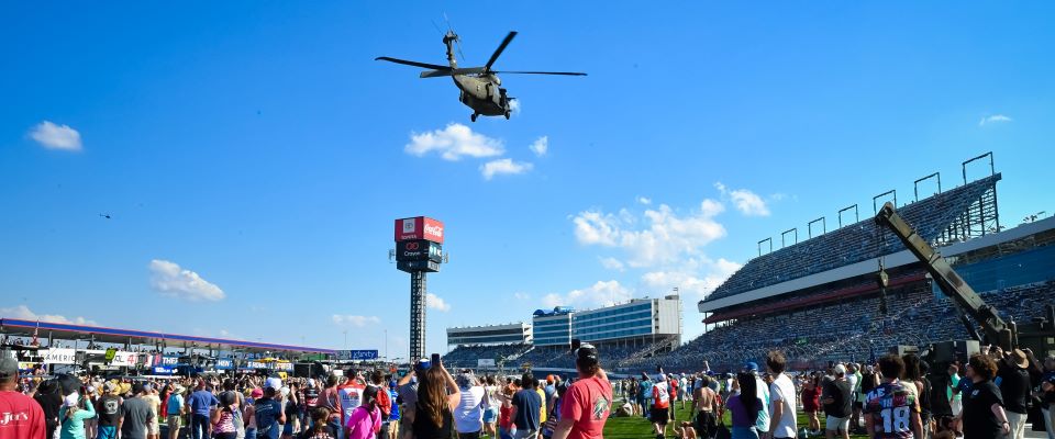 helicopter flies above rans at race track